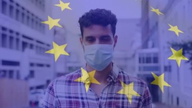 Yüz maskeli bir adamın üzerinde el salladığı bayrak animasyonu. küresel covid 19 salgın hastalık ve sağlık hizmetleri konsepti dijital olarak oluşturulmuş video.