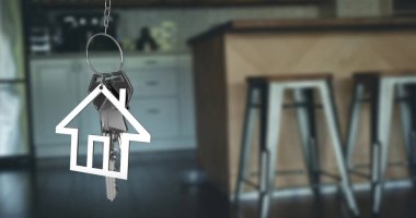 Image of silver house keys and house shaped key fob hanging over an out of focus open plan kitchen  clipart