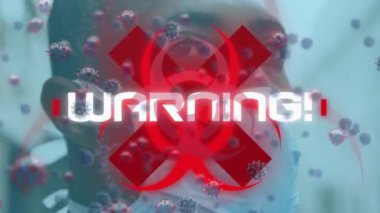 Yüz maskesi takan bir adam için uyarı metni ve virüs hücrelerinin canlandırılması. küresel covid 19 salgın konsepti dijital olarak oluşturulmuş video.