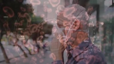 Yüz maskeli adamın üzerinde hareket eden kovid 19 hücrenin animasyonu. küresel covid 19 salgın hastalık ve sağlık hizmetleri konsepti dijital olarak oluşturulmuş video.