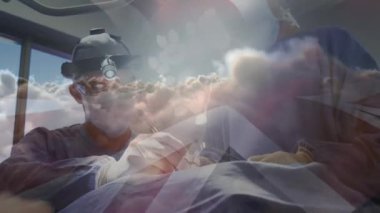 Ameliyat sırasında doktorların üzerinde İngiliz bayrağının canlandırılması. küresel tıp, sağlık ve teknoloji konsepti dijital olarak üretilen video.