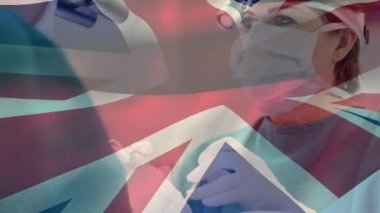 Ameliyat sırasında doktorların üzerinde İngiliz bayrağının canlandırılması. küresel tıp, sağlık ve teknoloji konsepti dijital olarak üretilen video.