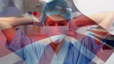 Yüz maskesi takan kadın doktor için İngiliz bayrağı animasyonu. küresel tıp, sağlık ve teknoloji konsepti dijital olarak üretilen video.