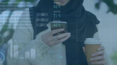 Akıllı telefon kullanan tesettürlü bir kadının finansal veri işleme animasyonu. küresel iş, finans, bağlantılar ve teknoloji konsepti dijital olarak oluşturulmuş video.