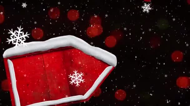 黒の背景に赤い光のスポットに対して赤い看板のポストに落ちて雪のアイコンや雪をフレーク クリスマス フェスティバルとお祝いのコンセプト — ストック動画