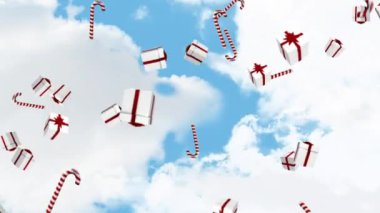 Bulutlu gökyüzünde düşen hediyelerin ve baston şekerlerin animasyonu. Noel, gelenek ve kutlama konsepti dijital olarak oluşturuldu.