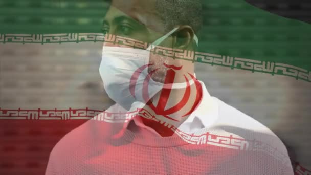 Animación Bandera Irán Ondeando Sobre Hombre Con Máscara Facial Durante — Vídeo de stock