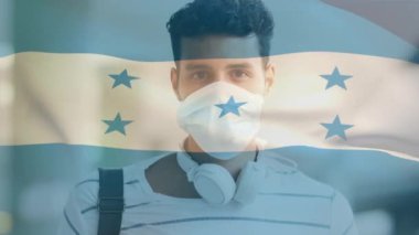 Covid 19 salgını sırasında yüz maskesi takan adamın üzerinde sallanan Honduras bayrağı animasyonu. küresel covid 19 salgın konsepti dijital olarak oluşturulmuş video.