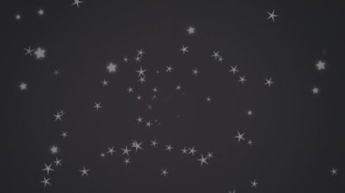 Mavi arkaplanda yüzen çoklu yıldız simgelerinin dijital animasyonu. Noel şenliği ve kutlama konsepti