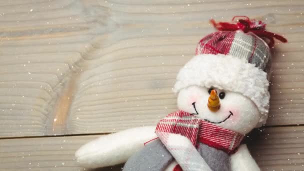 Schnee Der Aus Nächster Nähe Von Schneemannspielzeug Auf Eine Holzoberfläche — Stockvideo