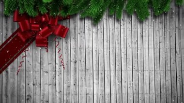 Ahşap arka planda kırmızı bir Noel yayının animasyonu. Noel, gelenek ve kutlama konsepti dijital olarak oluşturuldu.