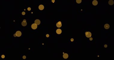 Siyah arka planda yüzen çoklu sarı noktaların animasyonu. Tebrikler, parti, yıldönümü, düğün ve iyi dilekler konsepti dijital olarak oluşturuldu..