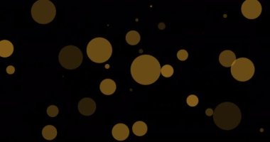 Siyah arka planda yüzen çoklu sarı noktaların animasyonu. Tebrikler, parti, yıldönümü, düğün ve iyi dilekler konsepti dijital olarak oluşturuldu..