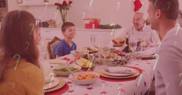 Animation Candy Canes Falling Smiling Caucasian Family Having Dinner Christmas — Stock Video