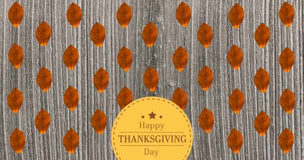 Animation of happy thanksgiving day text over wooden background with autumn leaves — Stock Video