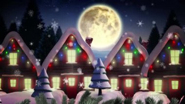 Kış mevsiminde birden fazla ağaç ve evin üzerine düşen kar taneleri gece gökyüzünde aya karşı. Noel şenliği ve kutlama konsepti