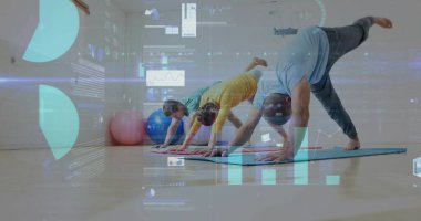 Aşağıya bakan köpek pozu eşleri spor salonunda yoga yaparken, paspaslar, toplar, veri tabloları. Sağlık, canlılık, uyum, güç, motivasyon, modern, egzersiz