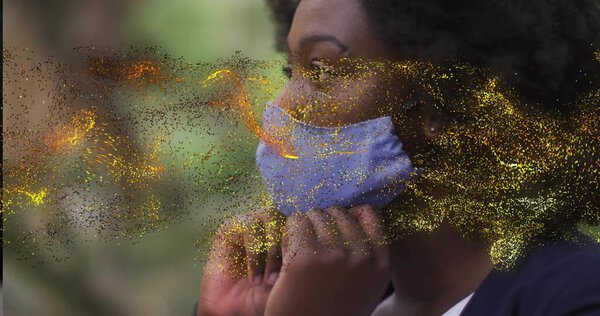 Adjusting woman in blazer securing light blue face mask in park, golden swirl overlay, copy space. Health, wellness, outdoor, nature, empowerment, focus, elegance