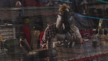 Kadın kaynakçı miğfer vizörünü kaldırıyor ve dijital kaplama altındaki kaynaklara el feneri yerleştiriyor. Sanayi, zanaat, kesinlik, teknoloji, imalat, mühendislik, dayanıklılık