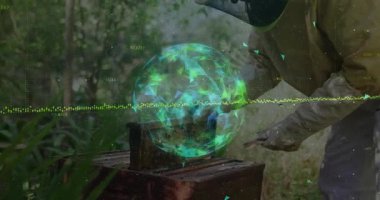 Erkek arıcı, hologram dalgalanan kovanları teknolojiyle izlerken kovan araçlarını kontrol ediyor. Apiary, technology, conservation, biodiversity, environment, research, innovation