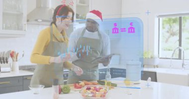 Kadın salata sosluyor ve erkek, mutfak adasında tableti tıkırdatıyor. Hologram piyasası grafiklerini izliyor. Mutfak, takım çalışması, dijital, teknoloji, konfor, tazelik, modern