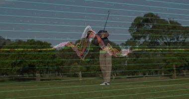 Golf oyuncusu golf analitik verileri ölçümleri gösterirken golf topuna vuruşunu yapıyor. Spor, kesinlik, teknoloji, performans, açık hava, eğitim, analitik