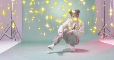 Altın kıvılcımlar düşerken ve moda hamlesi ve ceket açılırken mankenler ışıkların altında çömeliyor. Çağdaş, dinamik, enerjik, stüdyo, sanatsal, hareketli, canlı