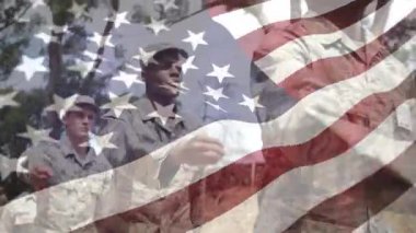 Ormanda yürüyen askerler tören için bayrak direğine yaklaşıyorlar, bayrak sallayarak selamlıyorlar. Vatanseverlik, disiplin, takım çalışması, açık hava, tören, doğa, üniforma