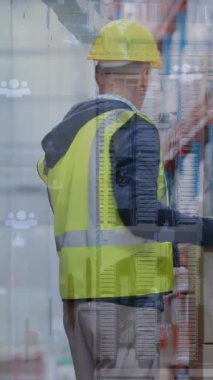 Animation of data processing over caucasian male supervisor holding his back in pain at warehouse. Logistics and business technology concept