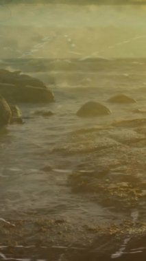 Animasyon tekniği ve film şeridi açık gökyüzüne karşı deniz ve kayalık kıyılarda. Dijital kompozit, çoklu pozlama, günbatımı, kamera, doğa, manzara ve fotoğraf konsepti.