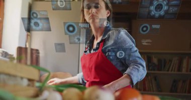 Tezgahta holografik UI kullanan ve akıllı yemek takibi için yeşil soğan doğrayan olgun bir kadın. Fütürist, mutfak, teknoloji, yemek pişirme, akıllı, yenilik, ev