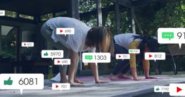 Anne ve kızı pembe yoga minderlerine basarak aşağı doğru giden köpek tutarak yüzen ölçüler oluşturuyorlar. Spor, sağlık, açık hava, aile, bağlantı, boş zaman, doğal