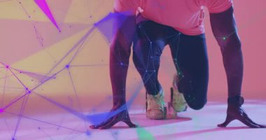 Erkek sporcu, sprinter duruşu benimsiyor, spor teknolojisini performans için uzuvlara yayıyor. Spor, fitness, teknoloji, dijital, hareket, performans, dayanıklılık