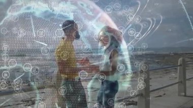 Denetleme sırasında kaldırımda nesne değiş tokuşu yapan çift. Teknoloji küresi el ele dolaşıyor. Çiftler, gezinti güvertesi, deniz kenarı, samimi, romantik, açık havada, beklemede.