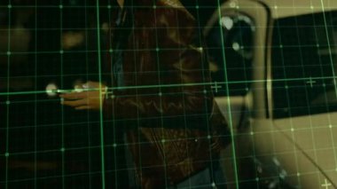 Gece park halindeki arabanın yanındaki akıllı telefonu dinleyen bir kadın yeşil ızgara tarama caddesini aktifleştiriyor. Kentsel, gözetleme, üst üste, kara, karamsar, bokeh, deri