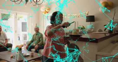 Kıdemli kadın mumları yakıyor ve doğum günü pastası için belirsiz yüzler sunuyor. Kutlama, aile, ev, festival, sıcak, toplanma, dekor