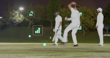 Kriket atıcısı koşuyor, bowling oynuyor, vurucu kaleyi kontrol ediyor, geçen oyuncular karbondioksit grafiklerini gösteriyor. Yarasa, alan, gece, projektörler, açık hava, veri, analiz