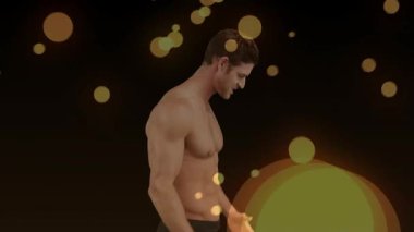 Erkek modelin vites değiştirmesi, kabartması, salması, yukarı bakması, siyah sette modadan önce altın bokeh. Adamım, eller, poz, jest, stüdyo, ışıklandırma, sıcak