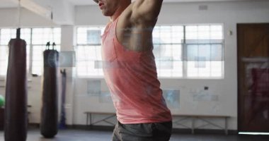 Tepeden tırnağa çıtayı yükselten ve jimnastik salonunda çömelen bir adam. Mavi HUD panelleri aktif edip analiz ediyor. Holografik, üstüste, eğitim, güç, odaklanma, analiz, fütüristik