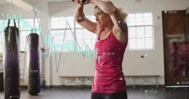 Nefes alan bir kadın, yukarıdan aşağıya kettlebell göğsü sallayan bir kadın, ardından da spor salonu çizelgeleri takip eden bir kadın. Zil, ağırlık, stüdyo, fitness, eğitim, yoğun, performans