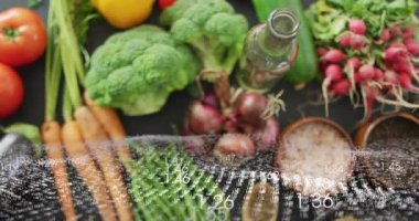 Translucent numeric overlay sweeping across table, revealing produce and utensils for cooking demo. Vegetables, flatlay, stilllife, studio, kitchenware, bowls, spoons