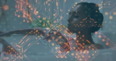 Cam kaldıran bir kadın, yüzün üstünü kapatan bir devre başlatırken aynı zamanda teknolojinin ne kadar iyi olduğunu gösteren bir yudum alıyor. Kadın, banyo, yakın çekim, rahatlama, fütüristik, holografik, dijital