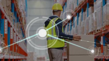 Warehouse worker pushing cardboard boxes down aisle, showing digital supply chain network graphics. Logistics, automation, supply chain, inventory, distribution, technology, industrial