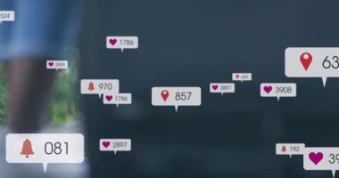 Animation of social media icons over low section of a woman with trolley bag walking on the street. Social media networking and business technology concept