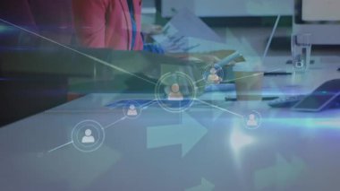 Animation of network of profile icons over diverse male and female colleagues at office. Global networking and business technology concept