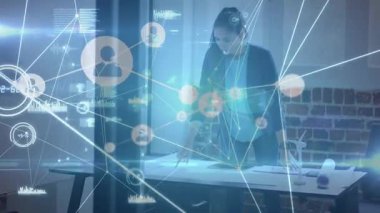 Animation of network of connections and data processing over businesswoman in office. Global connections, computing and digital interface concept digitally generated video.