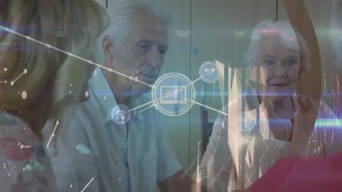 Animation of network of connections with icons over senior diverse people. Global connections and digital interface concept digitally generated video.