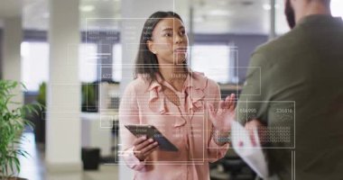 Animation of financial data processing over diverse business people in office. Global business, finances, computing and data processing concept digitally generated video.