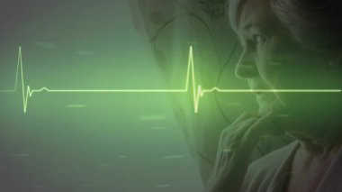 Animation of cardiograph over senior caucasian woman thinking. Global medicine and digital interface concept digitally generated video.