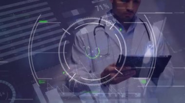 Animation of infographic interface with profile icons over caucasian male doctor using tablet. Digital composite, multiple exposure, medical, healthcare, database, communication, technology.